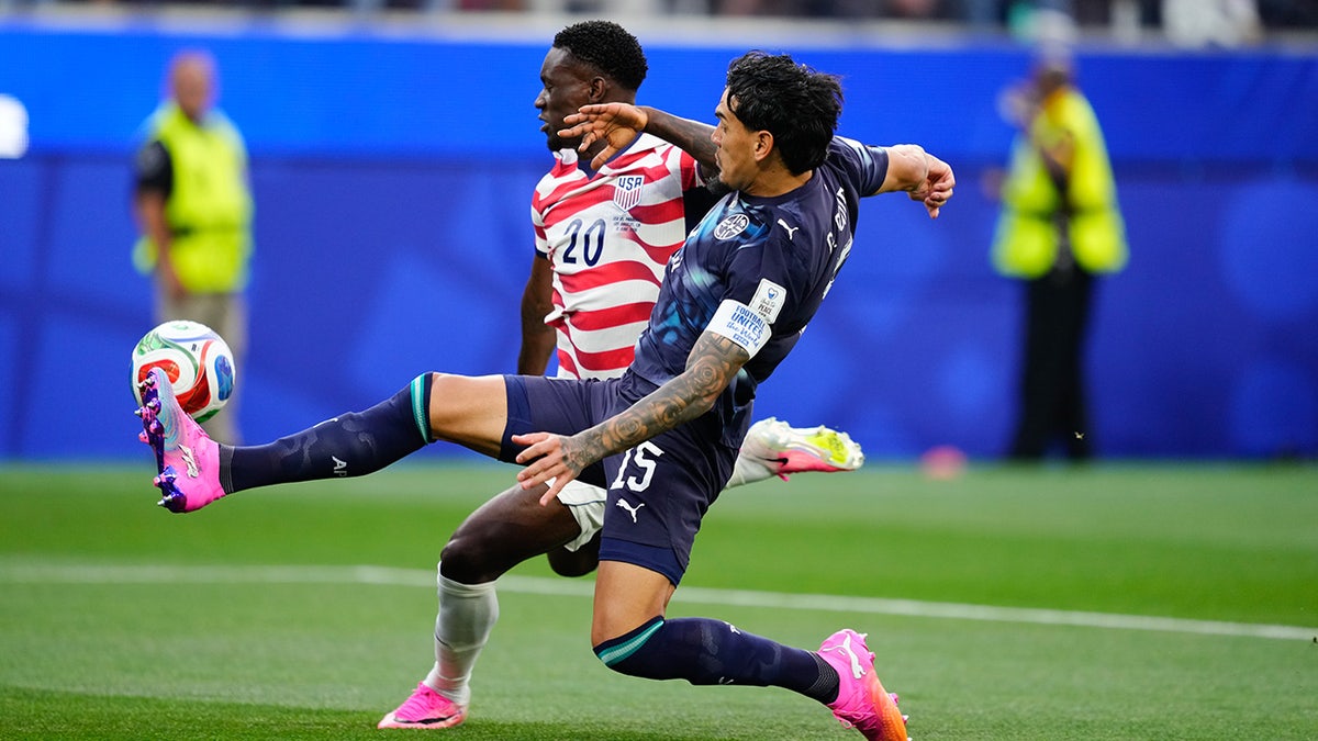 Folarin Balogun and Gustavo Gomez competing for the ball on a soccer field