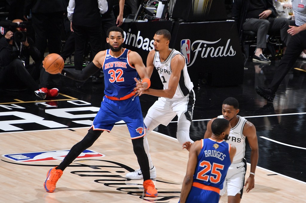 Karl-Anthony Towns #32 of the New York Knicks is guarded by Victor Wembanyama #1 of the San Antonio Spurs during Game Two of the 2026 NBA Finals on June 5, 2026 at Frost Bank Center in San Antonio, Texas.
