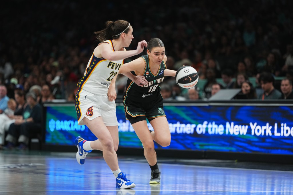 Pauline Astier of the New York Liberty dribbles the basketball while an Indiana Fever player defends.