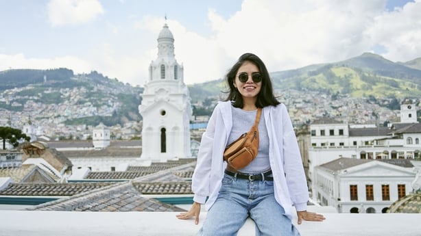 Woman sitting on roof of the cathedral of Quito, Ecuador