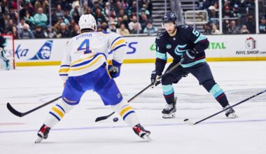Dec 14, 2025; Seattle, Washington, USA; Seattle Kraken center Shane Wright (51) looks to pass as Buffalo Sabres defenseman Bowen Byram (4) defends during the second period at Climate Pledge Arena. Mandatory Credit: Blake Dahlin-Imagn Images