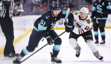 Nov 3, 2025; Seattle, Washington, USA; Seattle Kraken center Shane Wright (51) looks to pass past Chicago Blackhawks center Oliver Moore (11) in the second period™ at Climate Pledge Arena. Mandatory Credit: Kevin Ng-Imagn Images