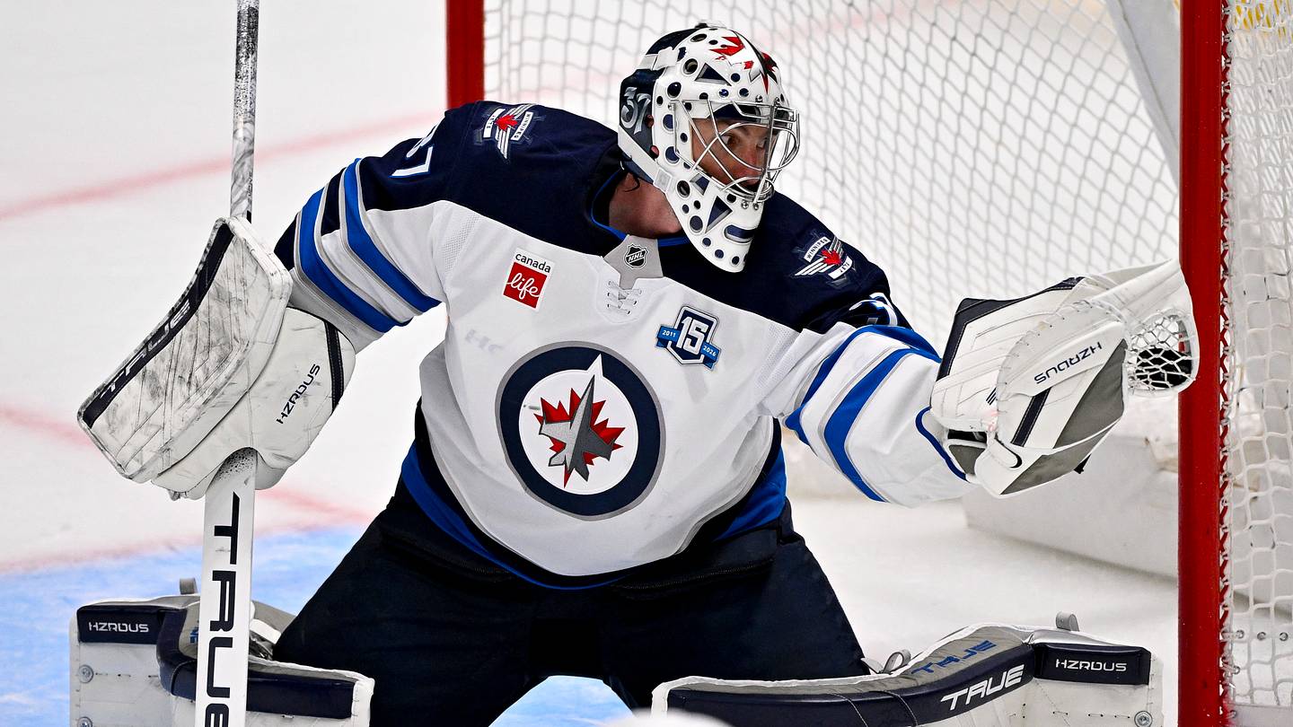 Apr 2, 2026; Dallas, Texas, USA; Winnipeg Jets goaltender Connor Hellebuyck (37) makes a glove save on a Dallas Stars shot during the second period at the American Airlines Center. Mandatory Credit: Jerome Miron-Imagn Images
