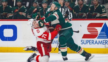 Mar 4, 2018; Saint Paul, MN, USA; Minnesota Wild defenseman Nate Prosser (39) hits Detroit Red Wings forward Dylan Larkin (71) in the first period at Xcel Energy Center. Mandatory Credit: Brad Rempel-USA TODAY Sports