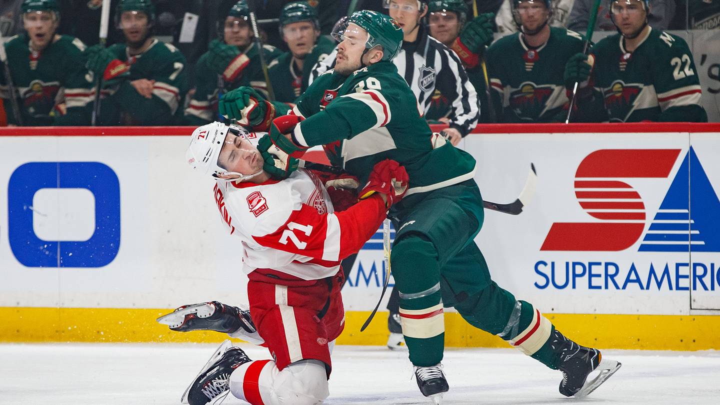 Mar 4, 2018; Saint Paul, MN, USA; Minnesota Wild defenseman Nate Prosser (39) hits Detroit Red Wings forward Dylan Larkin (71) in the first period at Xcel Energy Center. Mandatory Credit: Brad Rempel-USA TODAY Sports