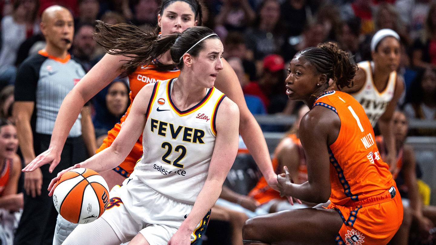 Jul 22, 2026; Indianapolis, Indiana, USA; Indiana Fever guard Caitlin Clark (22) dribbles the ball while Connecticut Sun forward Diamond Miller (1) defends in the second half at Gainbridge Fieldhouse. Mandatory Credit: Trevor Ruszkowski-Imagn Images