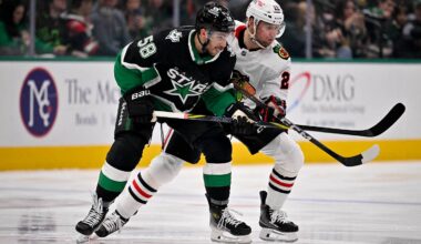 Mar 8, 2026; Dallas, Texas, USA; Dallas Stars left wing Michael Bunting (58) and Chicago Blackhawks left wing Andre Burakovsky (28) battle for control of the puck during the first period at the American Airlines Center. Mandatory Credit: Jerome Miron-Imagn Images