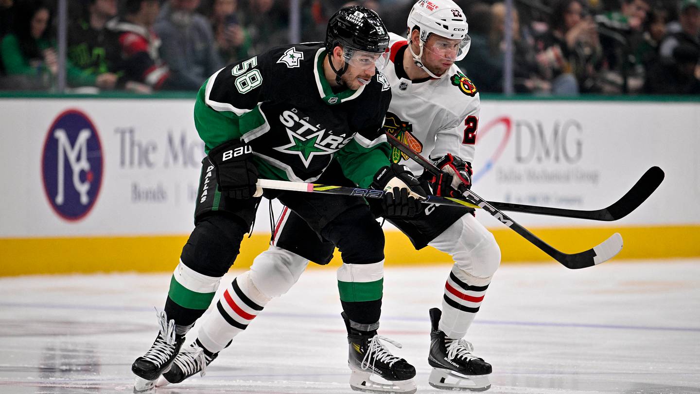 Mar 8, 2026; Dallas, Texas, USA; Dallas Stars left wing Michael Bunting (58) and Chicago Blackhawks left wing Andre Burakovsky (28) battle for control of the puck during the first period at the American Airlines Center. Mandatory Credit: Jerome Miron-Imagn Images