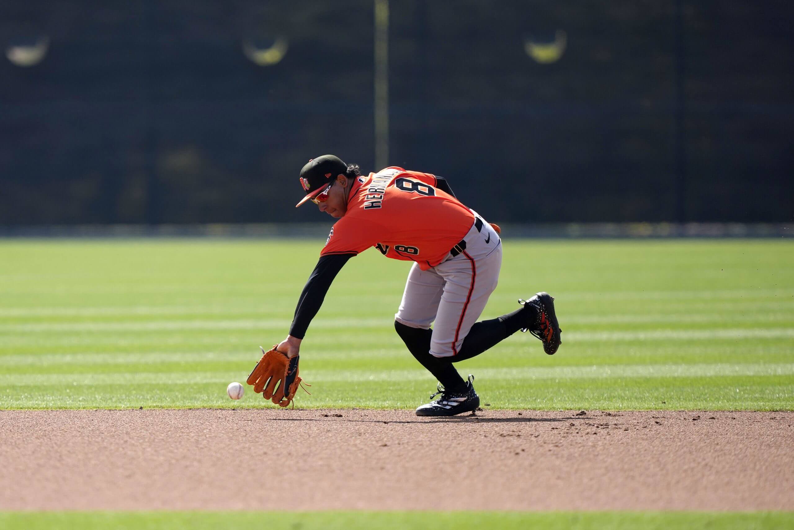 Luis Hernández ranges to his right to field a ground ball.