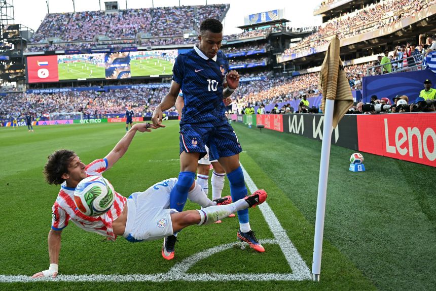Paraguay's midfielder Matias Galarza and France's forward Kylian Mbappe fight for the ball on Saturday.