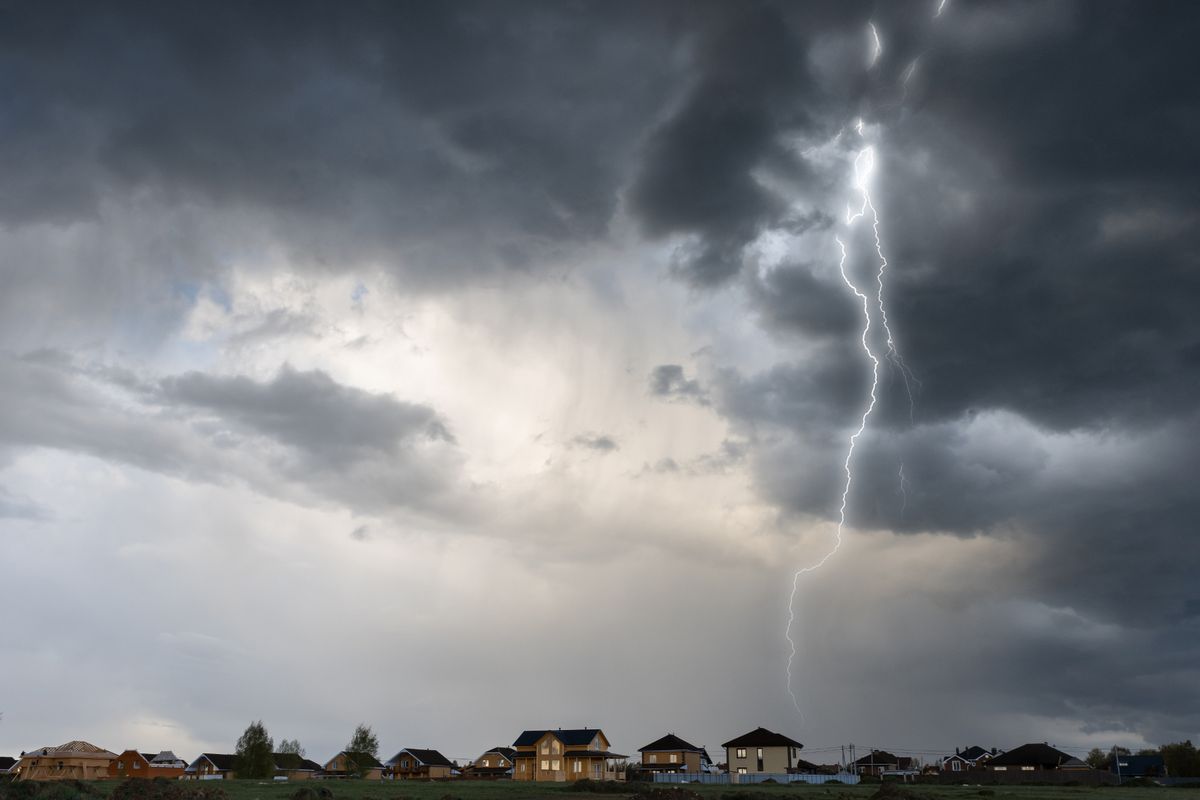Cloud storm sky with thunderbolt over the village in rural scene.
