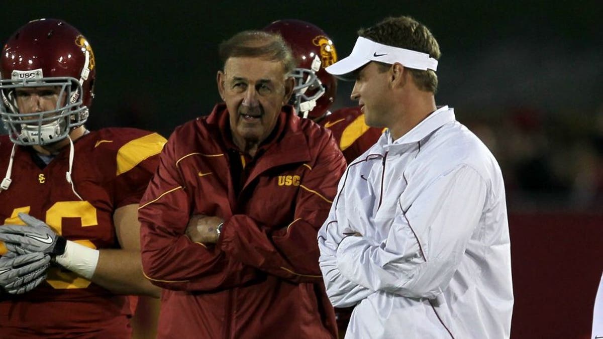 LOS ANGELES, CA - SEPTEMBER 11: Head coach Lane Kiffin (R) and his father and defensive coordinator Monte Kiffin of the USC Trojans talk during warmups for their game with the Virginia Cavaliers at Los Angeles Memorial Coliseum on September 11, 2010 in Los Angeles, California. (Photo by Stephen Dunn/Getty Images)