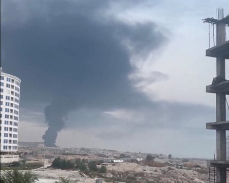 A plume of smoke rises after reported strikes, from Qeshm, Iran, on Thursday, in this screengrab obtained from a social media video