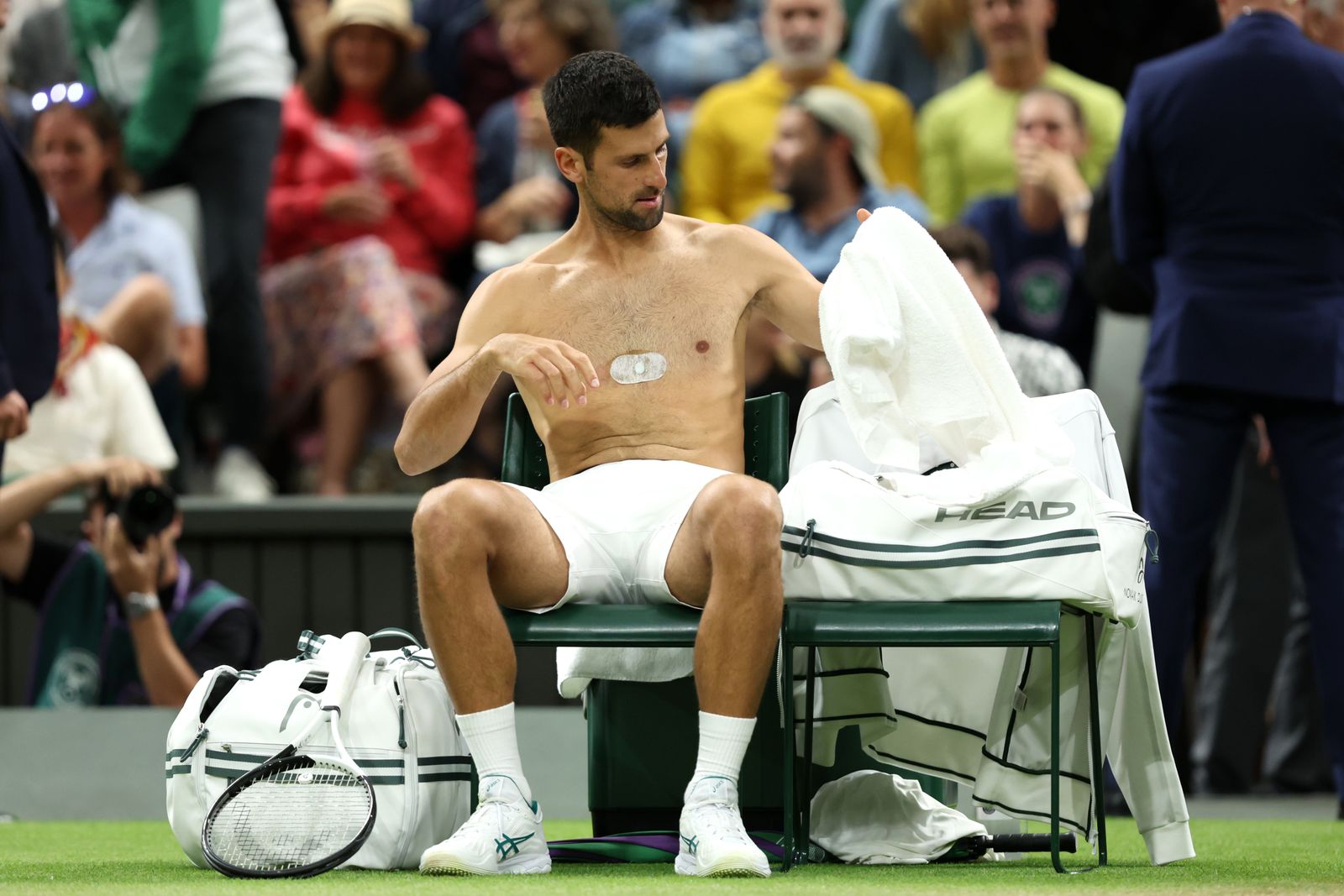 LONDON ENGLAND JULY 09 Novak Djokovic of Serbia changes shirt during a break against Hubert Hurkacz of Poland in the...