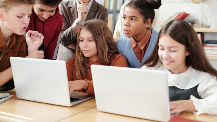 Kids reading from a laptop