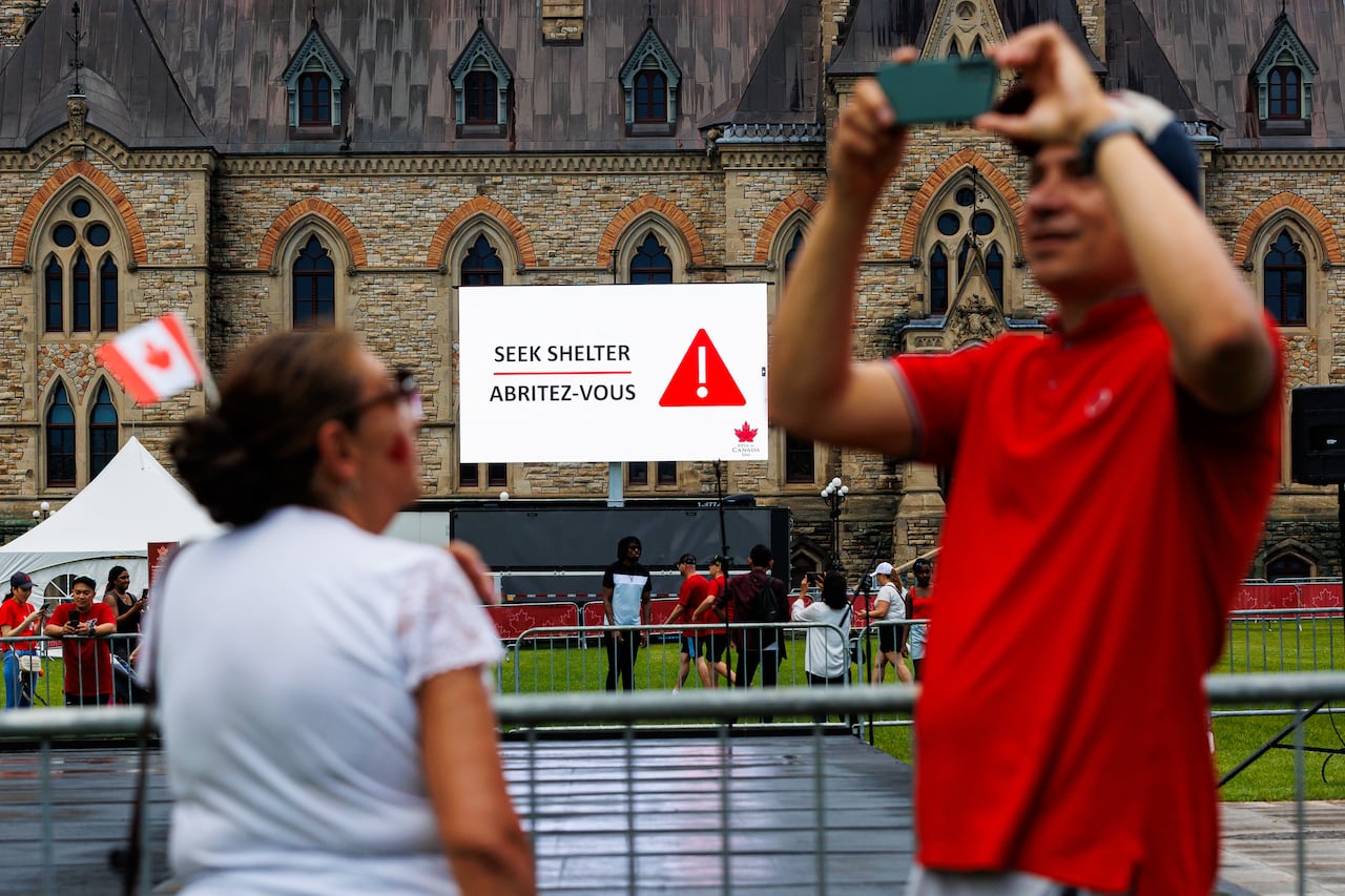 A seek shelter warning is seen on Parliament Hill during Canada Day festivities in Ottawa.