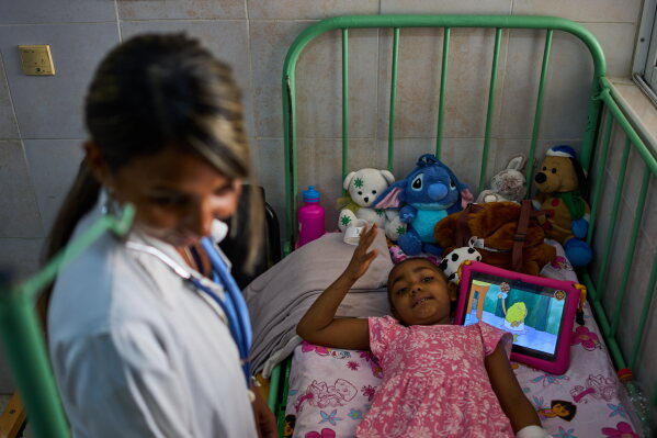 Karolina Silva Matis, a 6-year-old oncology patient, is examined by Dr. Yolainy Romero Rodriguez at the National Institute of Oncology and Radiobiology in Havana, Cuba, Wednesday, June 24, 2026. (AP Photo/Ramon Espinosa)