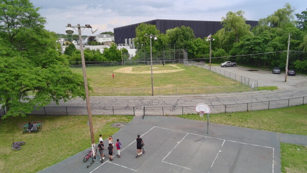 A data center built by the Markley Group looms over a ballpark and residential neighborhood in Lowell, Mass., on June 30, 2026. (AP Photo/Matt O'Brien)