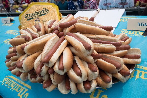 Hot dogs are displayed on stage ahead of the Nathan's Famous Fourth of July hot dog eating contest in New York's Coney Island on July 4, 2018. (AP Photo/Mary Altaffer, File)