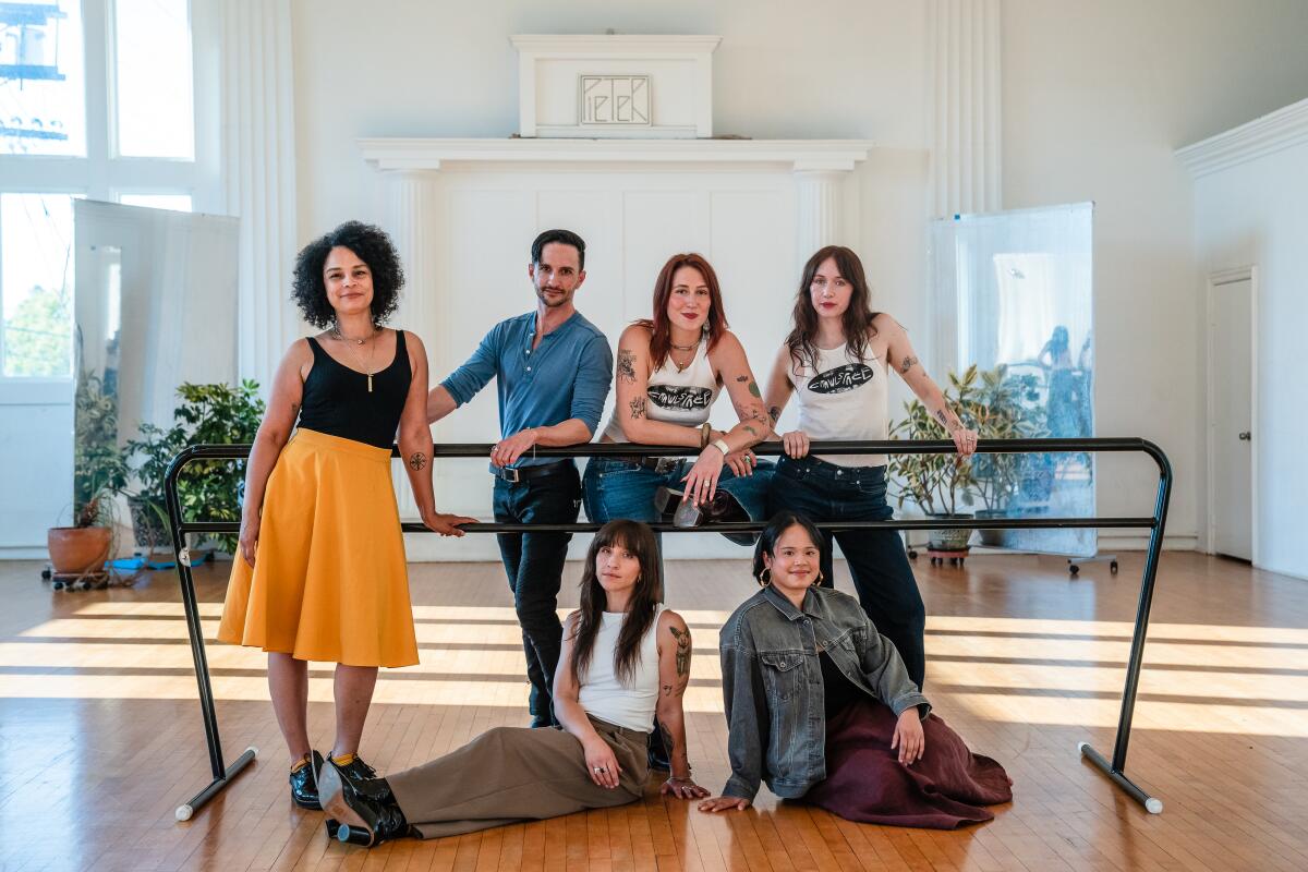 Six dance leaders posed around a portable ballet handrail.