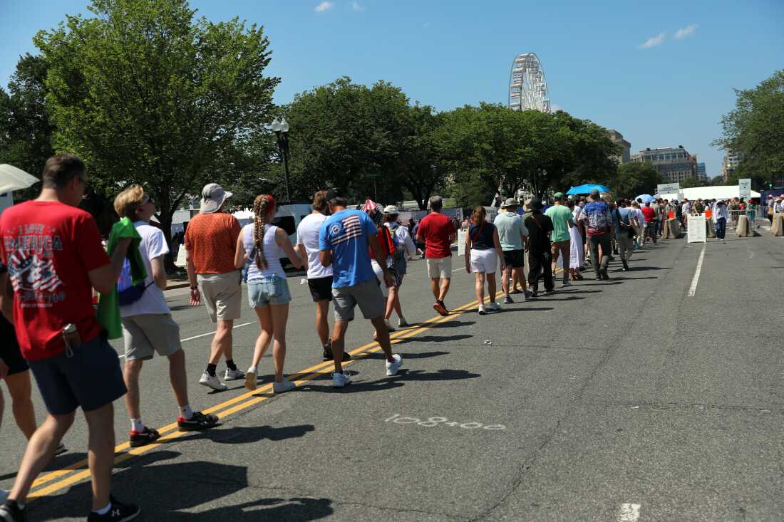 Attendees walk to attend Independence Day events honoring the nation's 250th anniversary, Saturday, July 4, 2026, on the National Mall in Washington.
