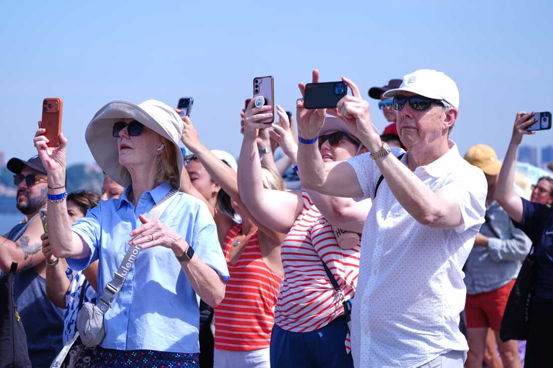 People watch as the French Air Force acrobatic squad Patrouille de France perform a flyover during the International Aerial Review on Saturday in New York.