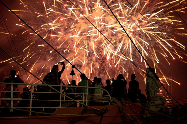 Crowds enjoy a fireworks show from Brooklyn Bridge Park in the Brooklyn borough of New York, Saturday, July 4, 2026. (AP Photo/Anna Connors)