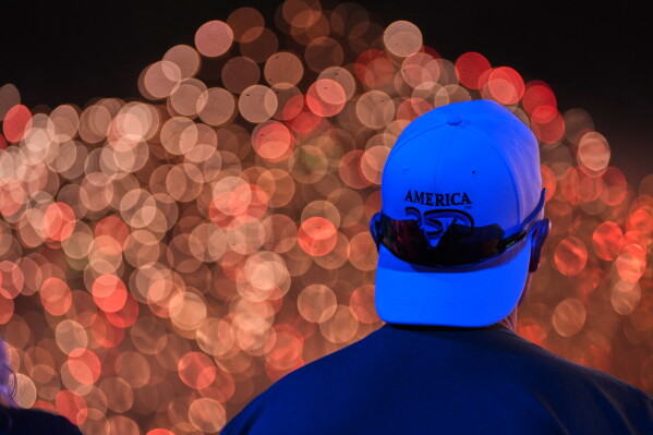 People watch fireworks during an Independence Day event honoring the nation's 250th anniversary, early Sunday, July 5, 2026, on the National Mall in Washington. (AP Photo/Alex Brandon)