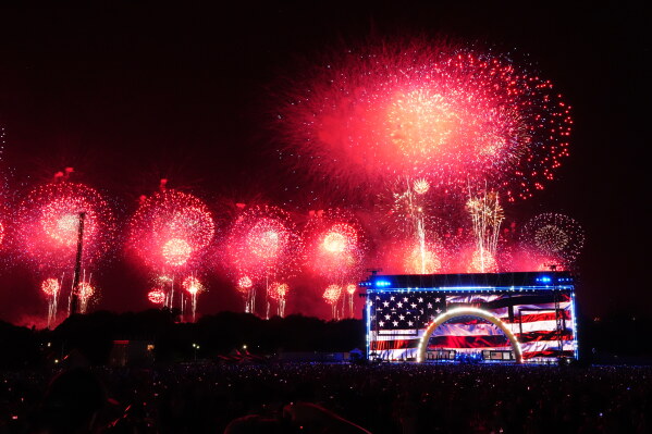 People watch fireworks at Salute to America, an Independence Day event honoring the nation's 250th anniversary, Sunday, July 5, 2026, on the National Mall in Washington. (AP Photo/Julia Demaree Nikhinson)
