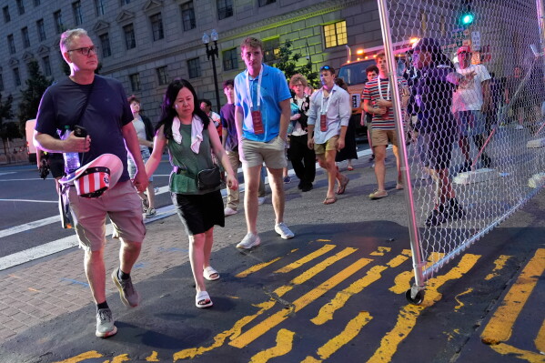People evacuate the National Mall due to weather while attending Independence Day events honoring the nation's 250th anniversary, Saturday, July 4, 2026, in Washington. (AP Photo/Pablo Martinez Monsivais)