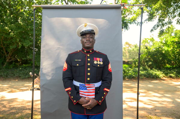 New U.S. citizen and twice-deployed U.S. Marine Sgt. Diakaria Sangare, from Guinea, poses for a portrait following the naturalization ceremony on Independence Day at George Washington's Mount Vernon, Saturday, July 4, 2026, in Alexandria, Va. (AP Photo/Rod Lamkey, Jr.)