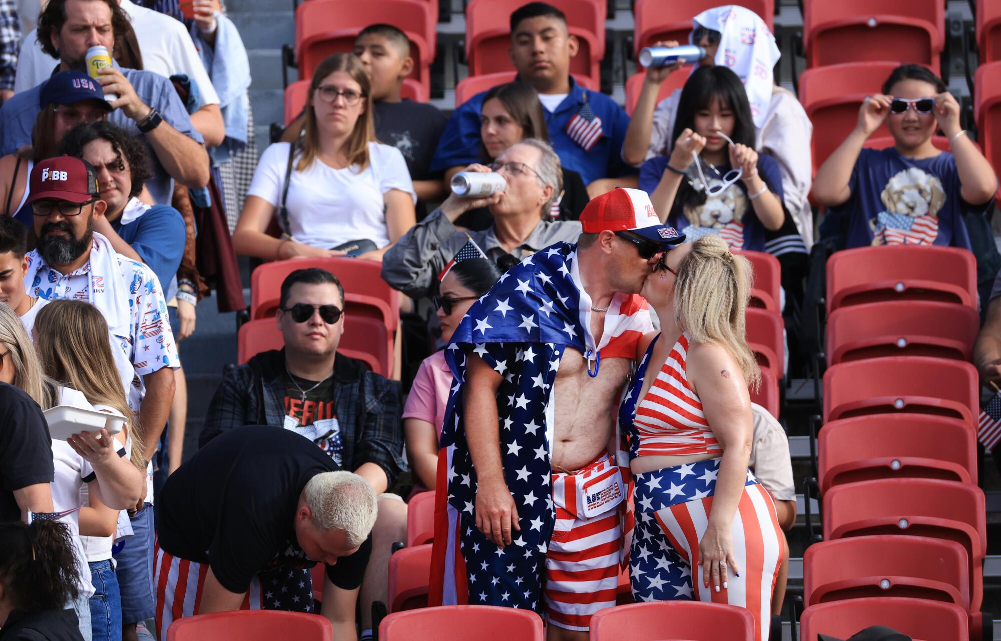 A couple in patriotic garb share a kiss.