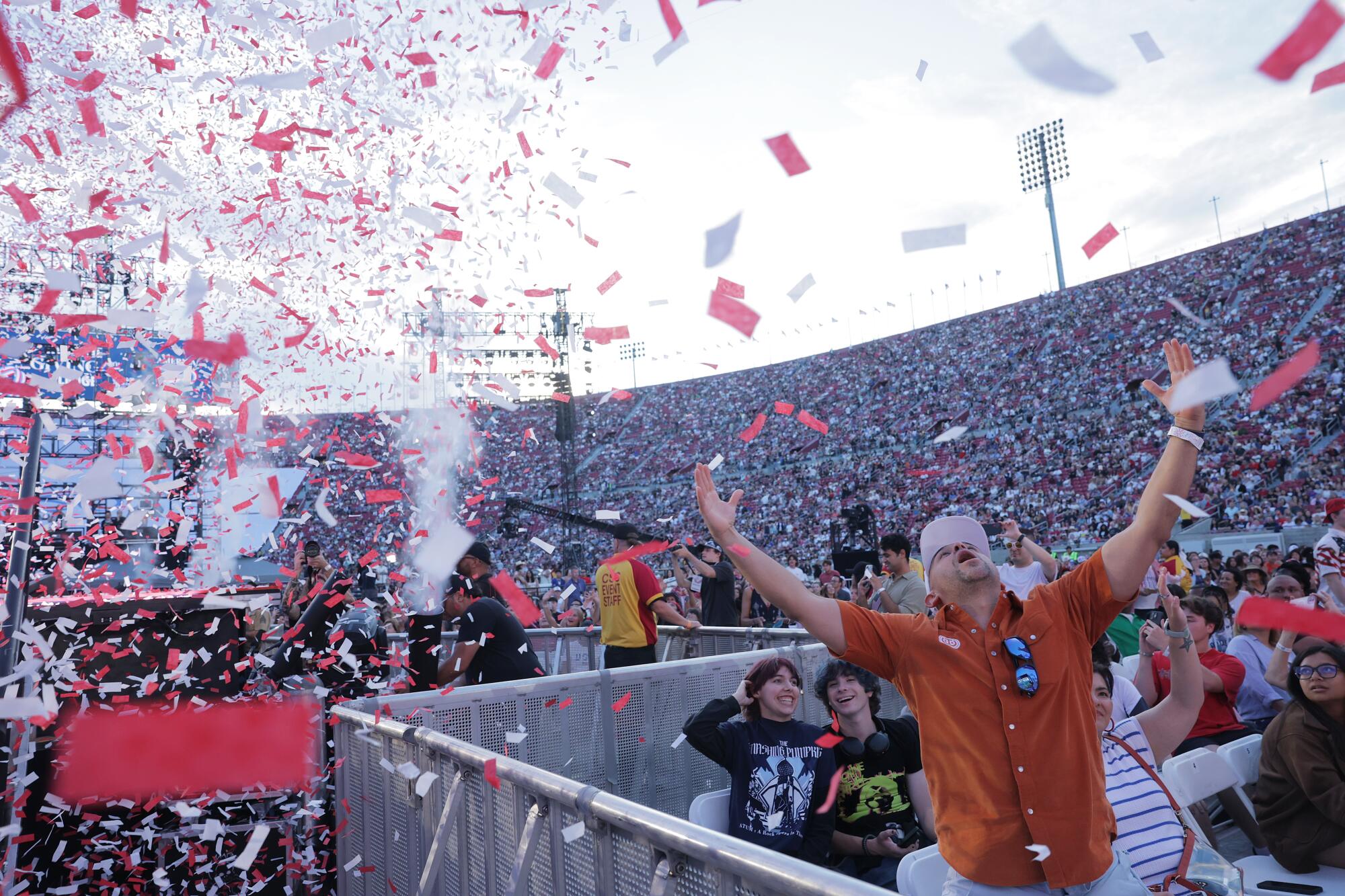 A concertgoer enjoys confetti.