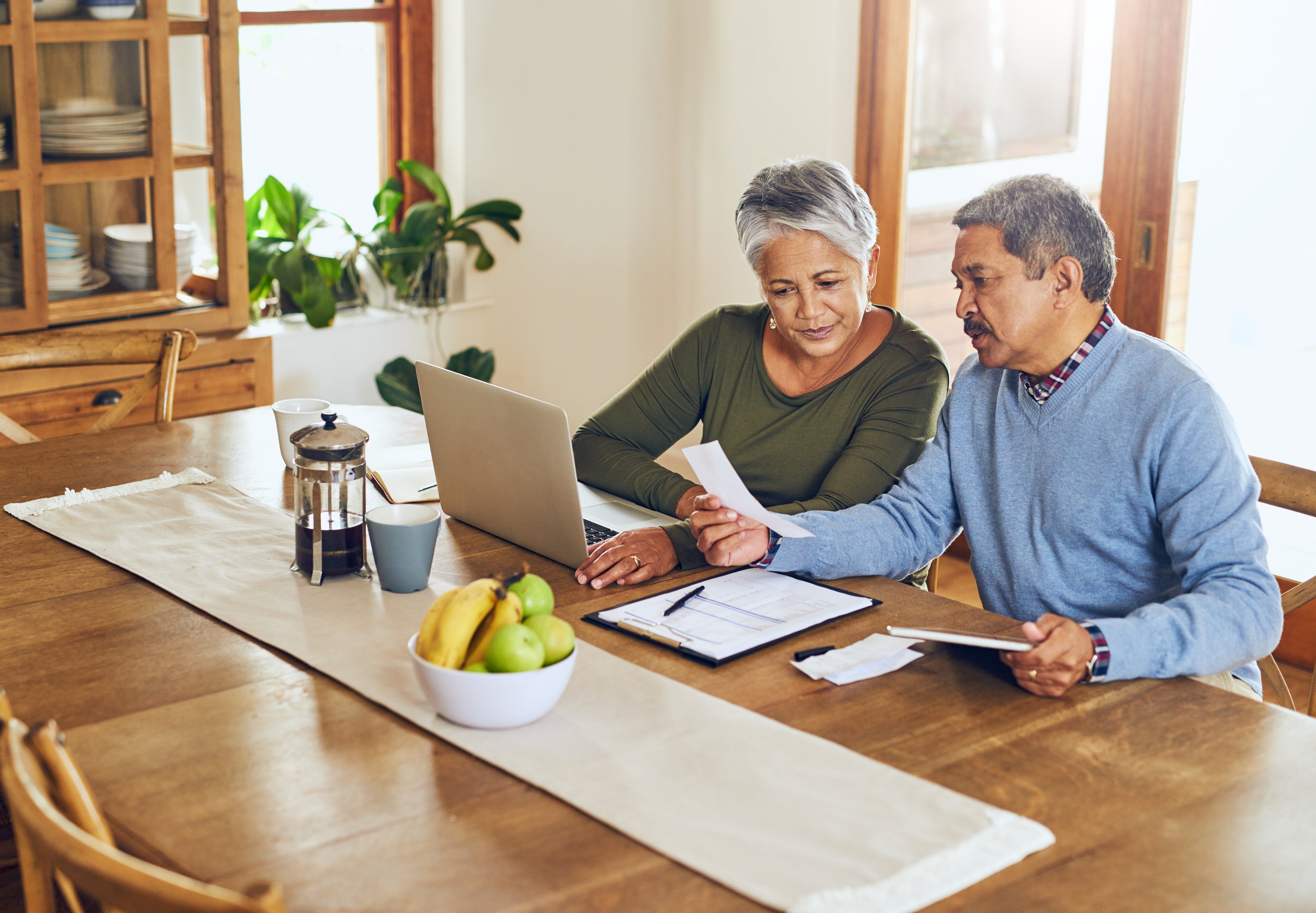 Two people sitting at table and working.
