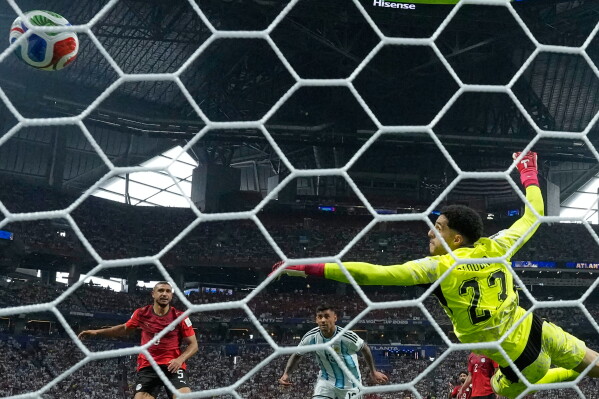 Argentina's Cristian Romero (13) scores their opening goal during the World Cup round of 16 soccer match between Argentina and Egypt in Atlanta, Tuesday, July 7, 2026. (AP Photo/Mike Stewart)