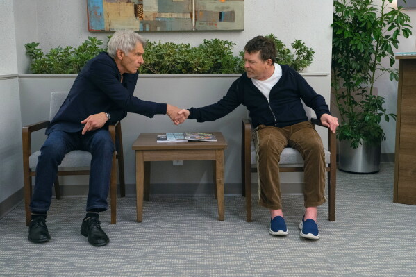 This image released by Apple TV+ shows Harrison Ford, left, and Michael J. Fox in a scene from "Shrinking." (Apple TV+ via AP)