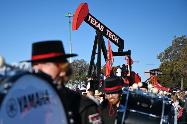 Texas Tech's band members walk past ESPN's College GameDay before the NCAA college football game between Texas Tech and BYU, Saturday, Nov. 8, 2025, in Lubbock, Texas. (AP Photo/Annie Rice,File)