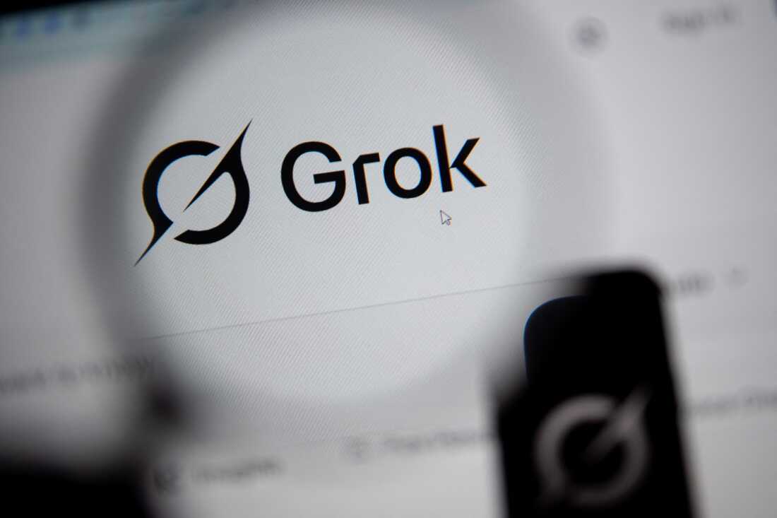 In this photo illustration, the Grok website is seen through a magnifying glass on a computer screen