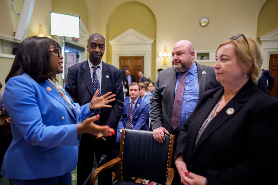 From left to right: Democratic Rep. Terri Sewell of Alabama talks with U.S. Election Assistance Commissioners Thomas Hicks, Benjamin Hovland and Christy McCormick after a House hearing on May 20.