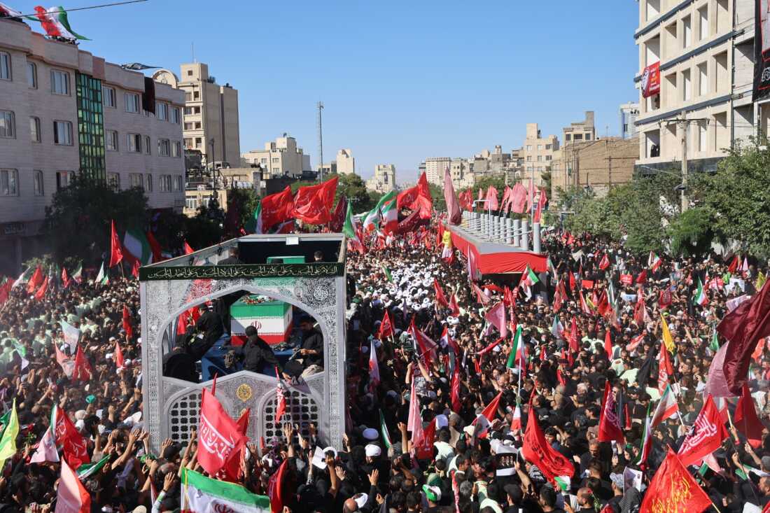 A truck carrying the coffins of the late Iranian Supreme Leader Ayatollah Ali Khamenei and members of his family moves through a main avenue lined with thousands of mourners during the final stage of funeral ceremonies in Mashhad, northeastern Iran, Thursday, July 9, 2026.