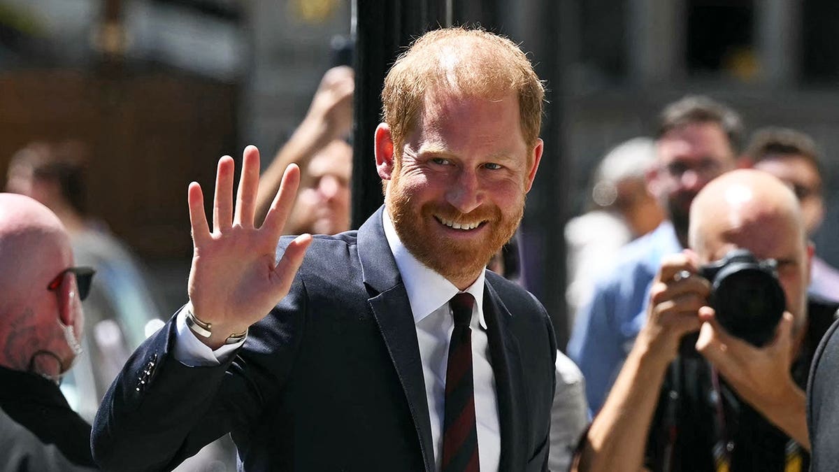 Prince Harry waving to the public in London.