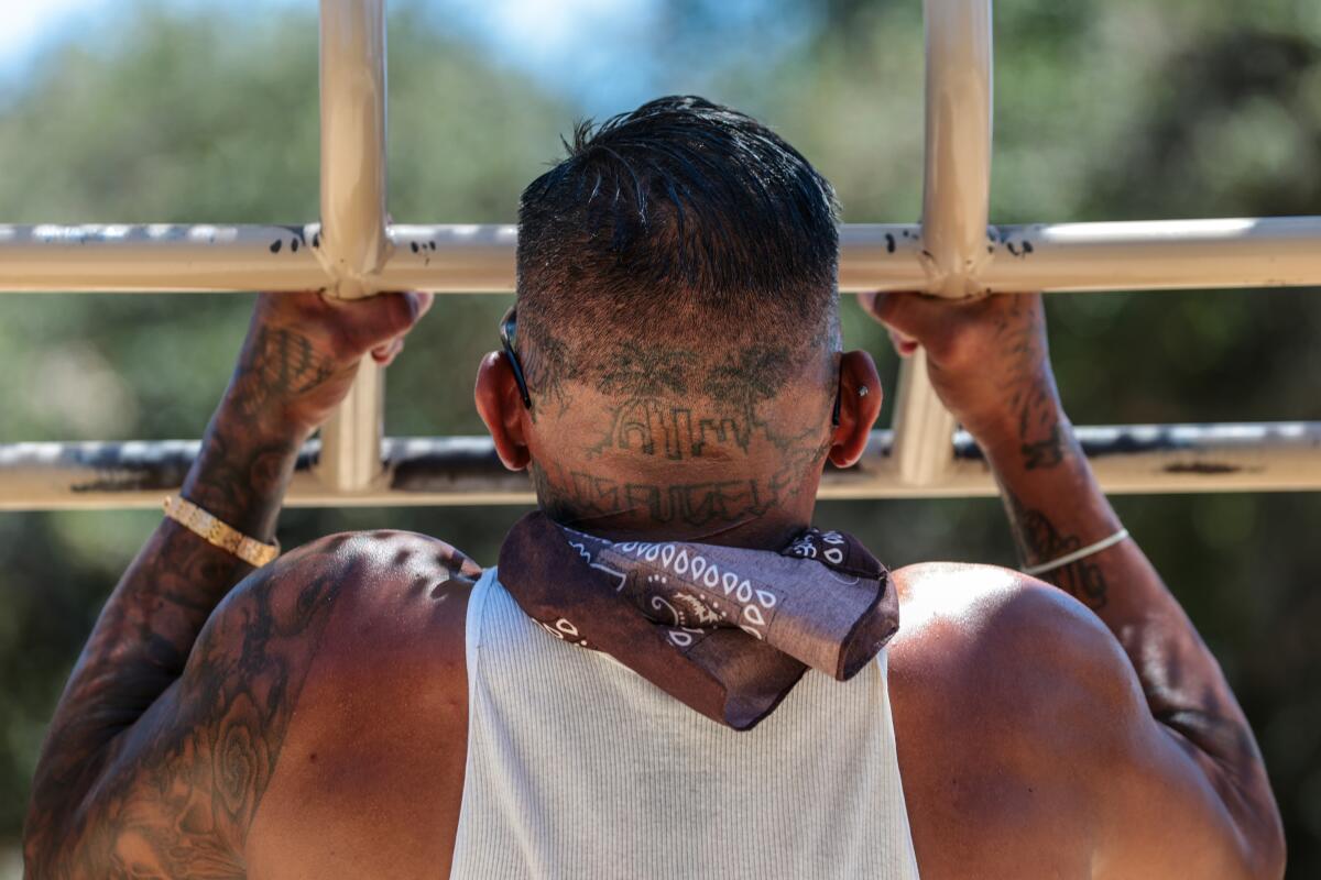 A man with a tattoo on his neck of the L.A. skyline