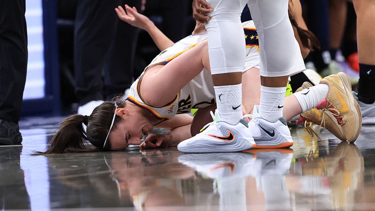 Caitlin Clark #22 of the Indiana Fever is fouled during a preseason game against the Dallas Wings.