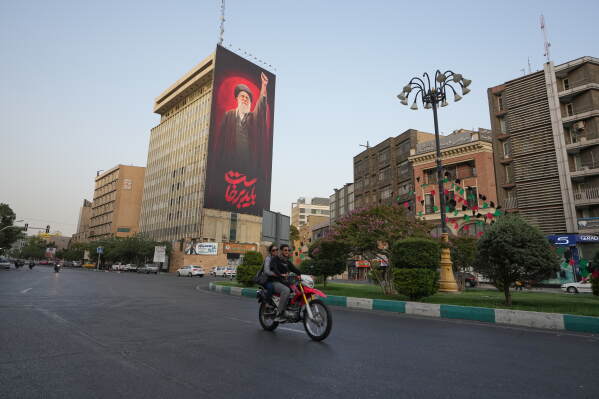 A billboard showing a portrait of the late Supreme Leader Ayatollah Ali Khamenei, hangs on a building ahead of his funeral ceremonies, in Tehran, Iran, Thursday, July 2, 2026. (AP Photo/Vahid Salemi)