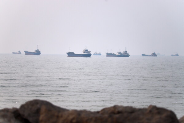 Commercial vessels are seen in the Strait of Hormuz off Bandar Abbas, Iran, Tuesday, June 30, 2026. (Amirhosein Khorgooi/ISNA via AP)