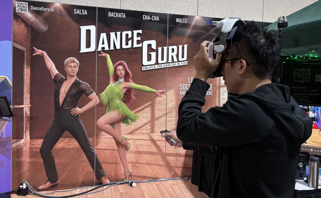 Entrepreneur David Huang tests out a VR headset while conducting demonstrations of the social dance lesson app Dance Guru at the Augmented World Expo in Long Beach Calif. June 17, 2026.