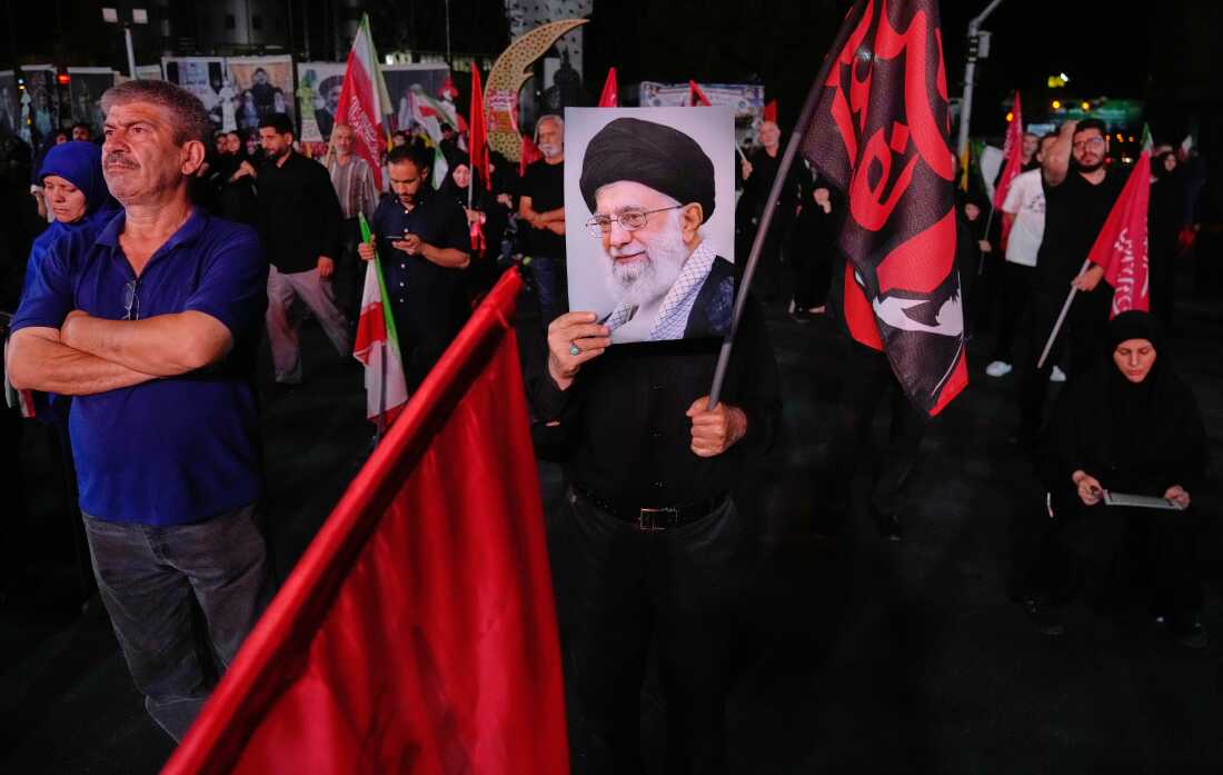 A man holds a poster of the late Iranian Supreme Leader Ayatollah Ali Khamenei in a gathering commemorating him at a square in Tehran, Saturday, July 11, 2026.