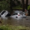 Search and rescue workers look through submerged vehicles. 