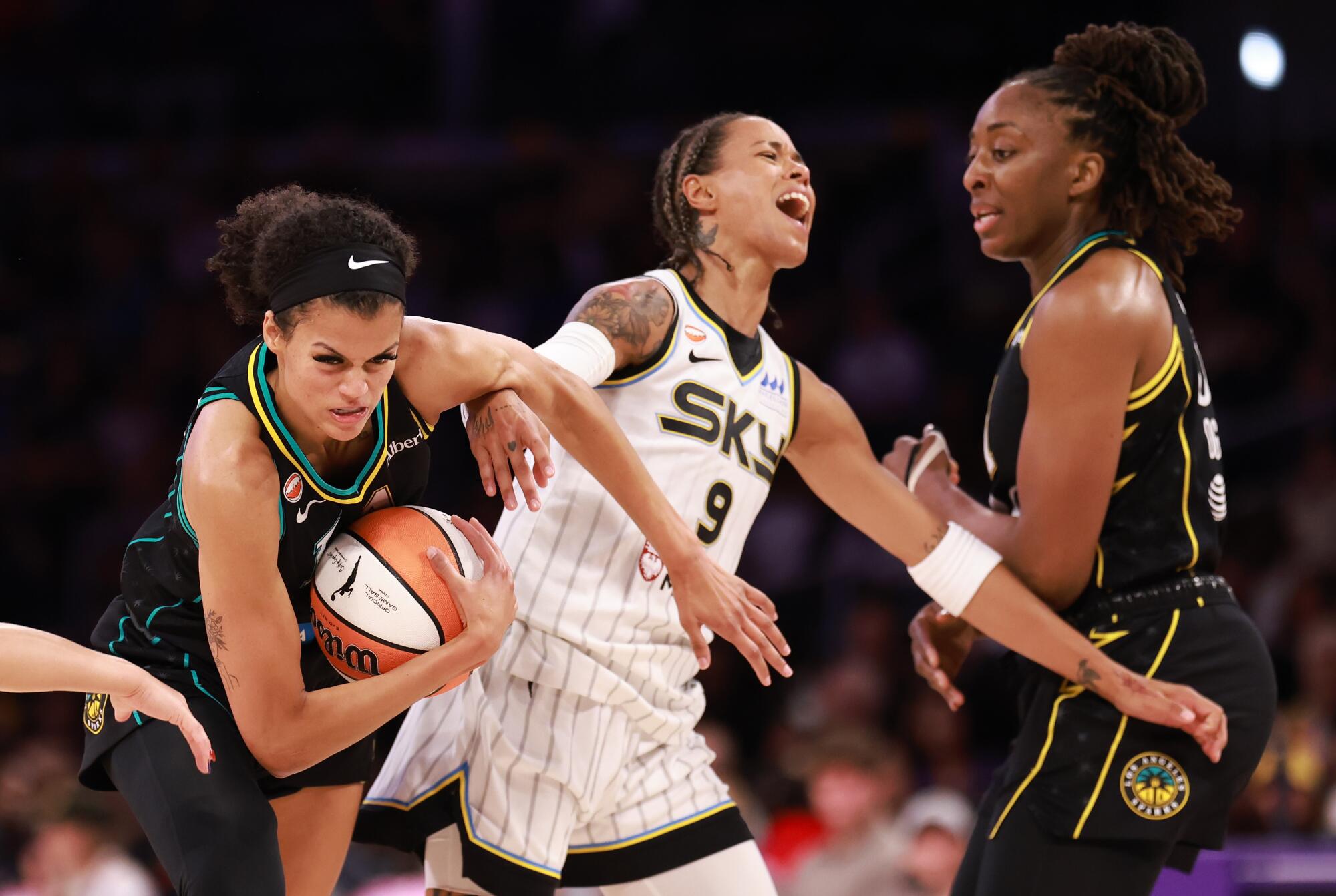 The Sparks' Rae Burrell protects the ball under pressure the Chicago Sky's Natasha Cloud at Crypto.com Arena on July 10.