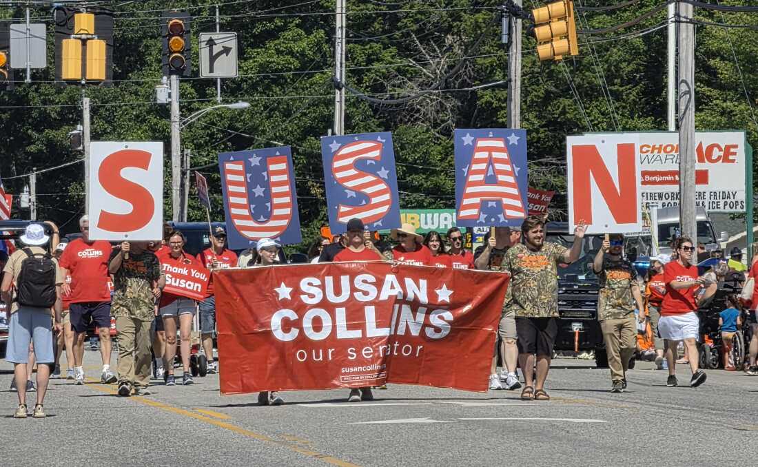 At the annual Moxie Day Parade in Lisbon, Maine, supporters of Sen. Susan Collins, R-Maine, march with signs and giant letters spelling S-U-S-A-N, on